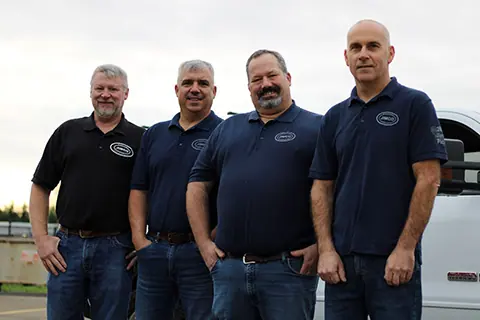 Jimco's leadership team in front of a Jimco truck