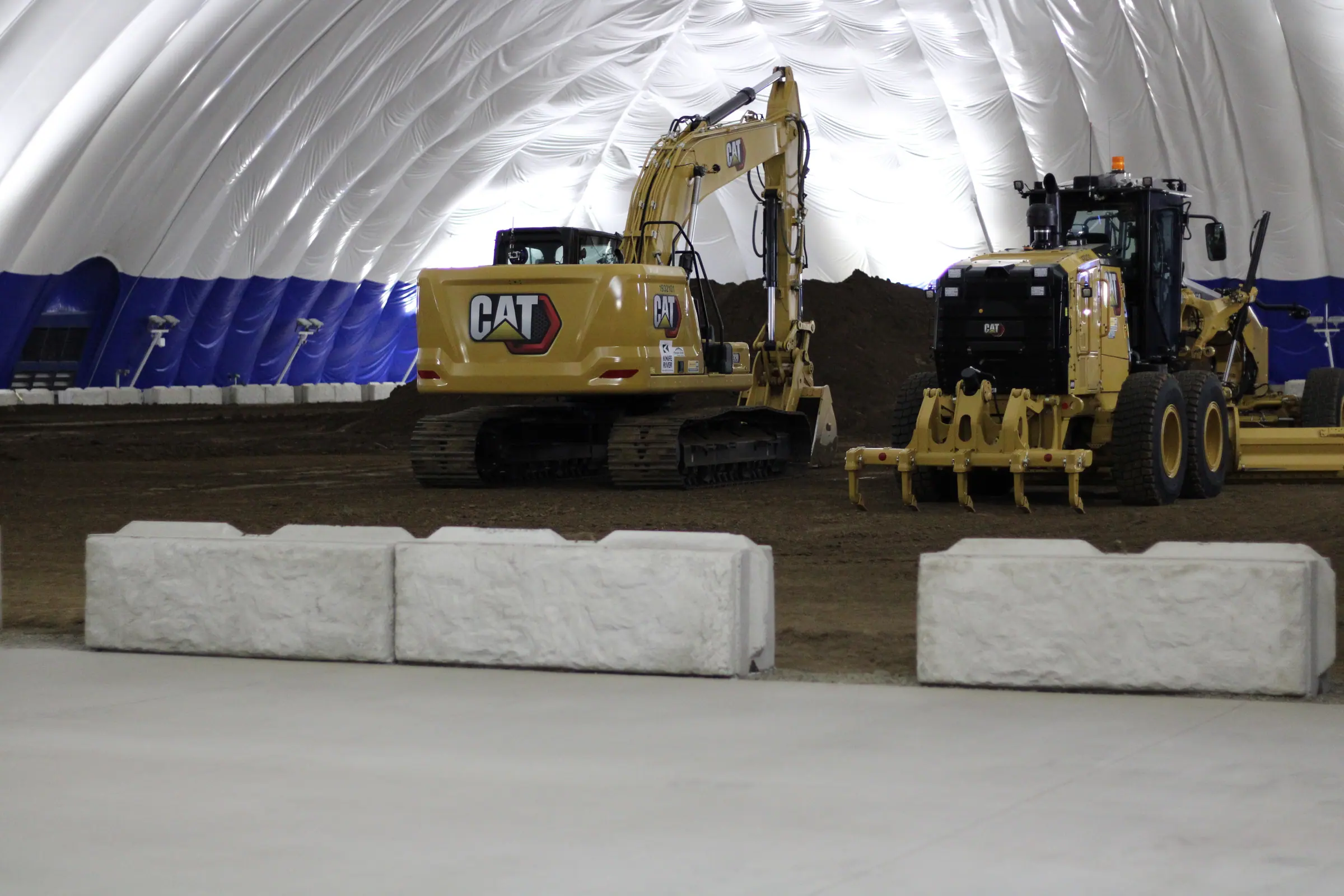 Heavy equipment training inside the Knife River dome, lit and powered by Jimco